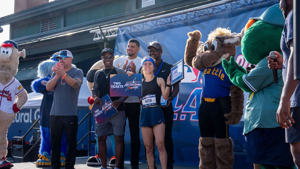 The winner of the overall female runner category, Maria Kedge, receives two 2025 All-Star Game tickets and poses for a photo with Jason Kendall, Dellin Betances, MLB Commissioner’s Ambassador Kenny Lofton and Adam Jones during the 2025 MLB All-Star 4.4 Miler at Center Parc Stadium on Sunday, July 13, in Atlanta.