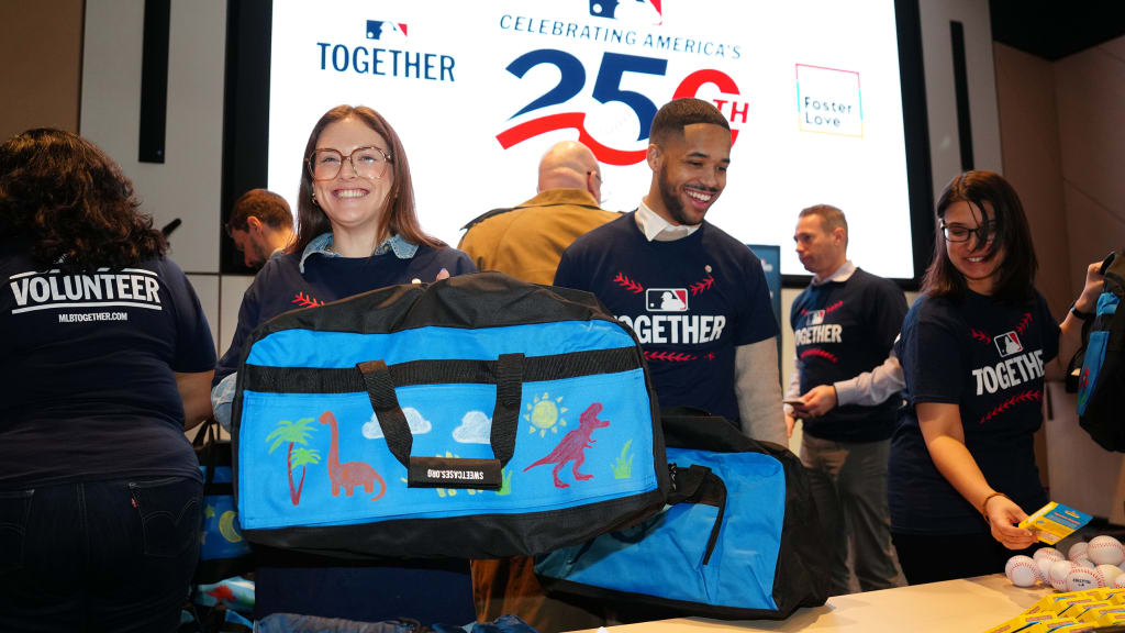 MLB volunteers assembled duffel bags filled with everyday items for foster children in need at the announcement. (Daniel Shirey/MLB Photos)