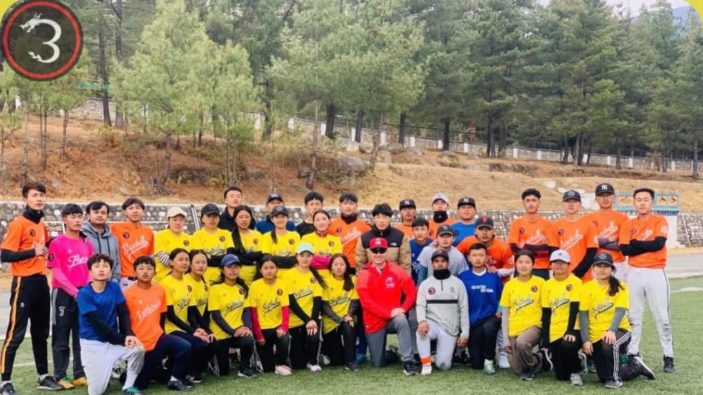 Paul Benoit, center, poses with Bhutan's baseball players. Photo courtesy Paul Benoit.