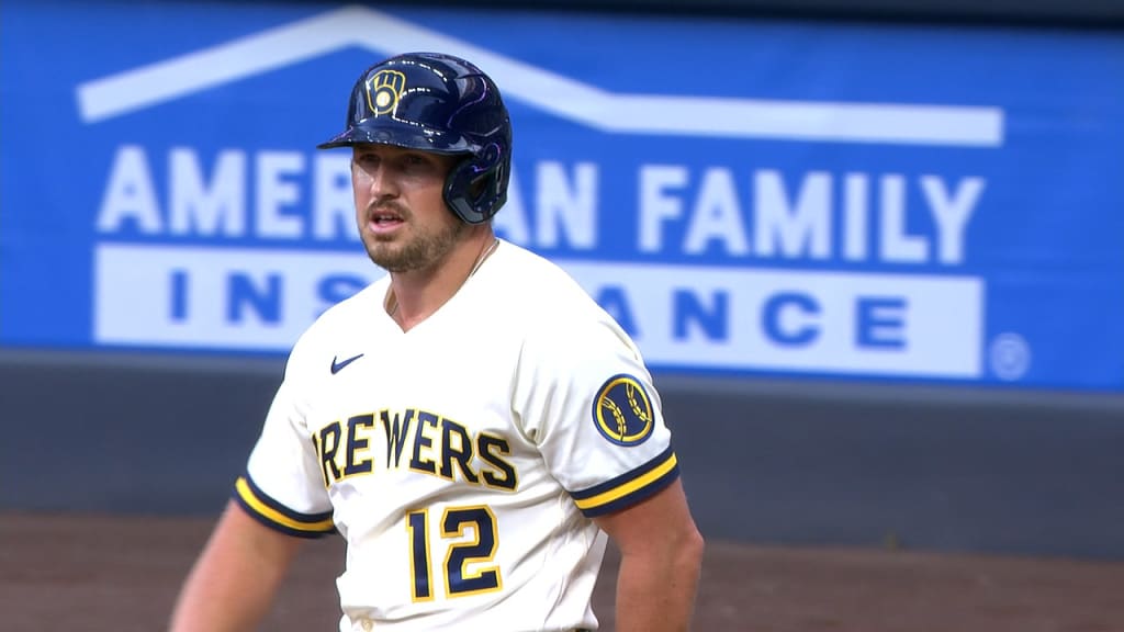 Milwaukee Brewers center fielder Garrett Mitchell leaves the game with a  shoulder injury, accompanied by head athletic trainer Scott Barringer,  center, and manager Craig Counsell, right, during a baseball game against  the