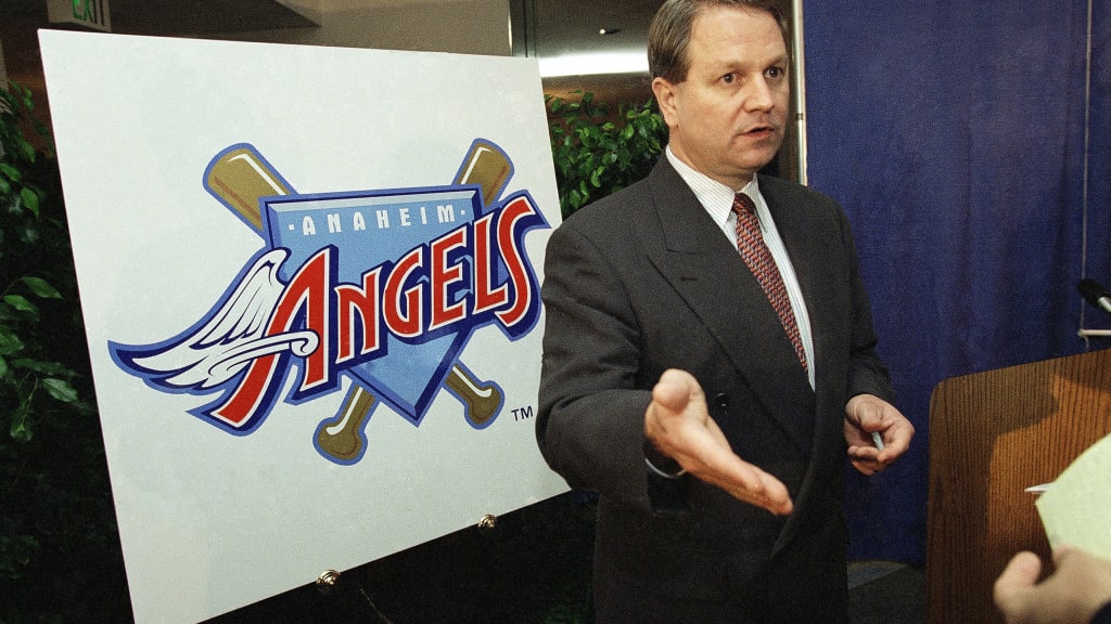 Team president Tony Tavares in front of the Angels' new logo in Nov. 1996. (AP Photo/Reed Saxon)