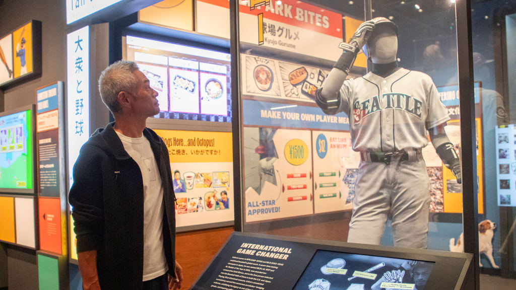 Hall of Fame Class of 2025 inductee Ichiro Suzuki stands at a display featuring artifacts from his career in "Yakyu | Baseball: The Transpacific Exchange of the Game." (Milo Stewart Jr./National Baseball Hall of Fame and Museum)