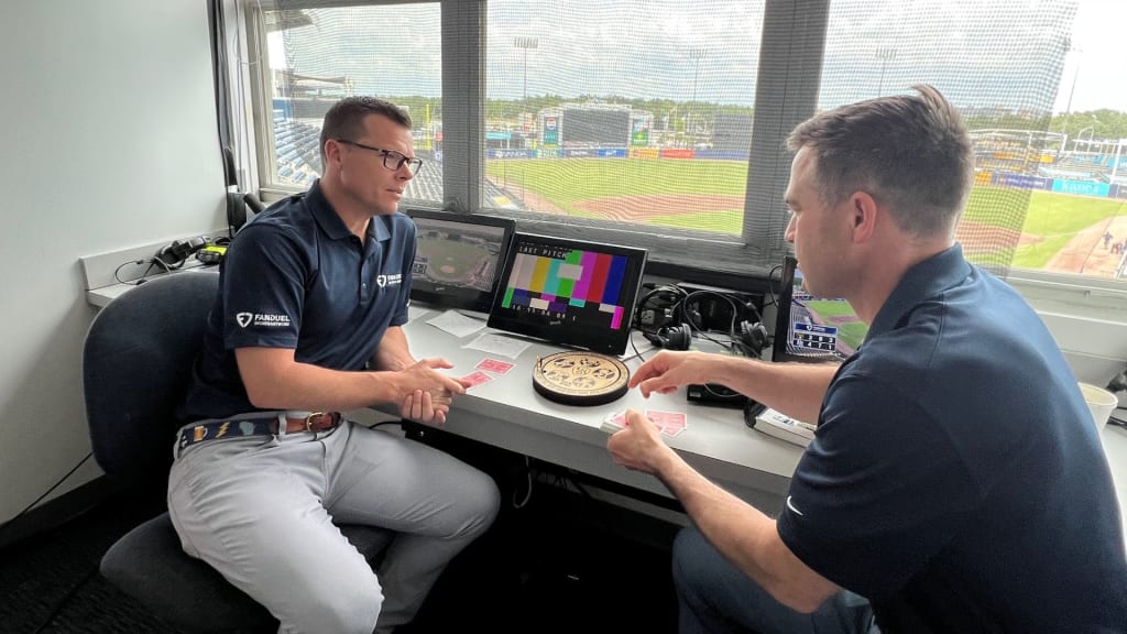 Jeff Levering and Vinny Rottino pass time during a rain delay by playing cribbage.