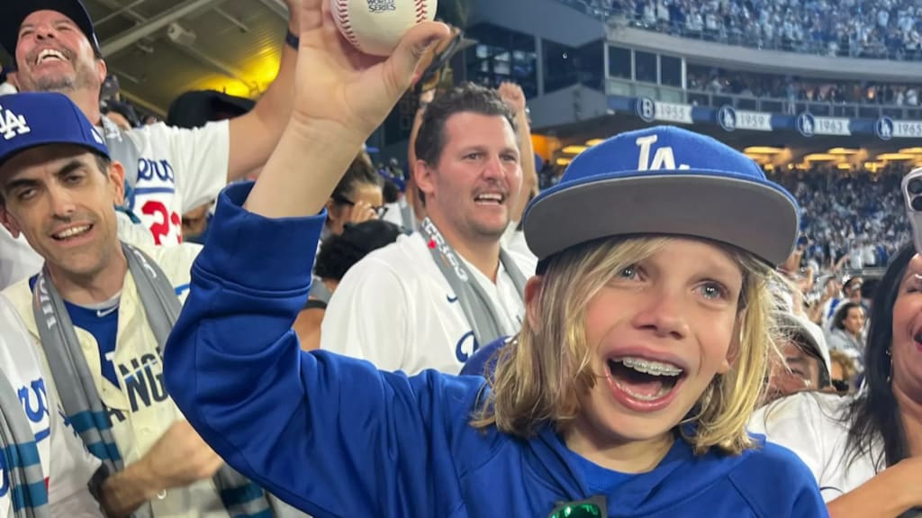 10-year-old Zach Ruderman holds up Freddie Freeman's walk-off grand slam ball in Game 1 of the World Series