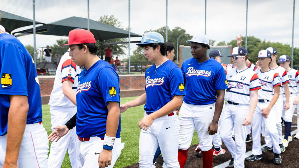 Players from the Texas Rangers Youth Academy and Baseball Pathways New Zealand shake hands.
