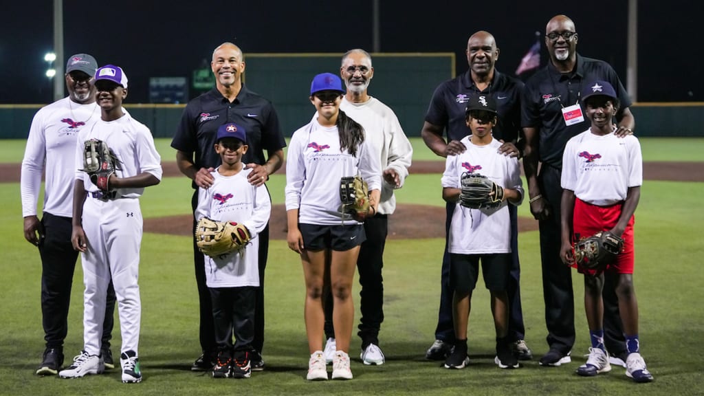 Eddie Davis, left, Darrell Miller, Jerry Manuel, Andre Dawson and Marvin Freeman pose with some of the kids who participated in the Andre Dawson Classic RBI 12U Tournament at New Orleans Youth Academy.