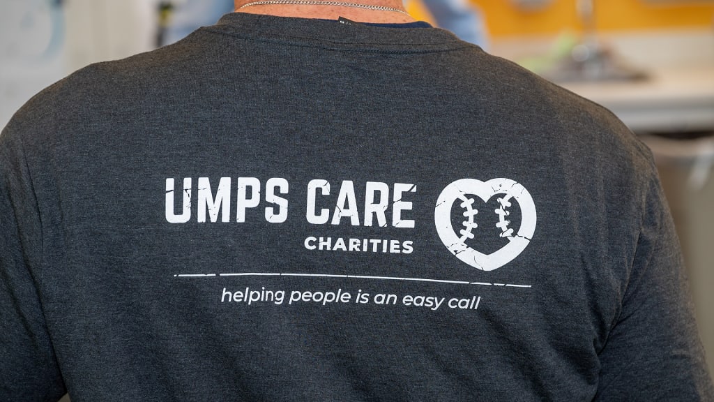 The UMPS CARE Charities shirt reads, "Helping people is an easy call."