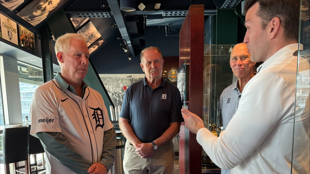 Randy O'Neal accepts his 1984 World Series ring from Ilitch Sports + Entertainment president Ryan Gustafson as O'Neal's 1984 Tigers teammates Dan Petry (left) and Alan Trammell look on.