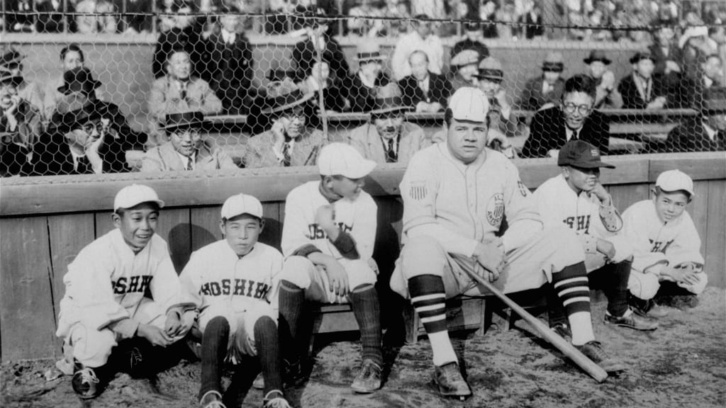 Babe Ruth poses for a photo with a group of Japanese batboys at Koshien Stadium in Osaka on Dec. 13, 1934. The Babe traded caps with one of the boys.