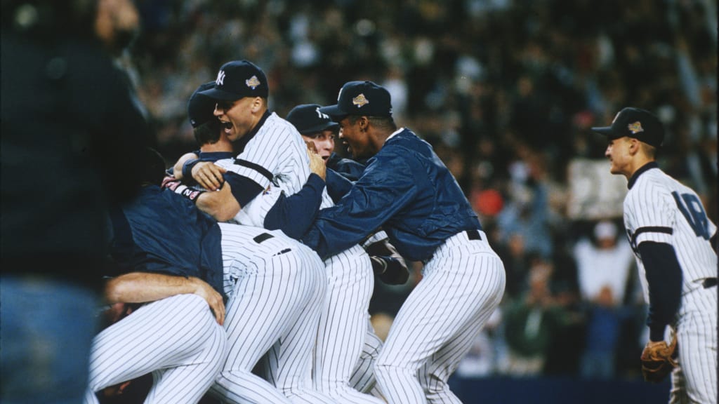 The Yankees celebrate winning the 1996 World Series with -- yup, you guessed it -- World Series patches on the side of their caps.