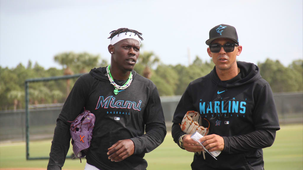 Jazz Chisholm Jr. confers with outfield coach Jon Jay during Spring Training 2023.