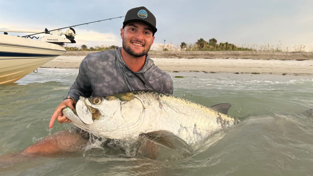 Shane McClanahan poses with the catch of the day, a tarpon. / Photo courtesy of Jake Rogers