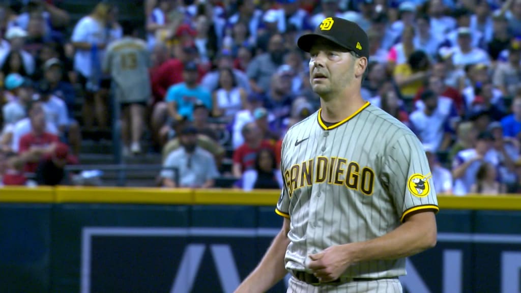 Rich Hill of the San Diego Padres walks of the field after