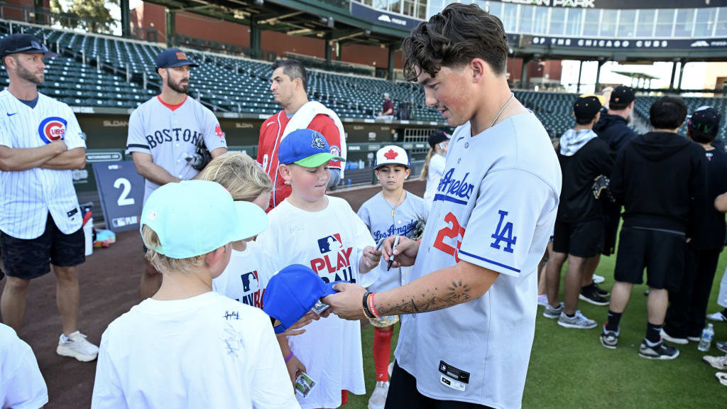 Logan Wagner signs autographs for young fans at an MLB PLAYBALL event. (Norm Hall/MLB Photos via Getty Images)