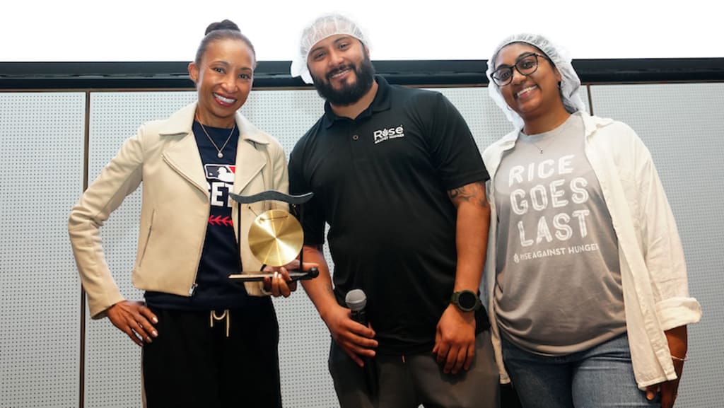 Senior vice president of social responsibility April Brown poses with representatives from Rise Against Hunger after receiving an award during the MLB Together volunteer event on March 31.