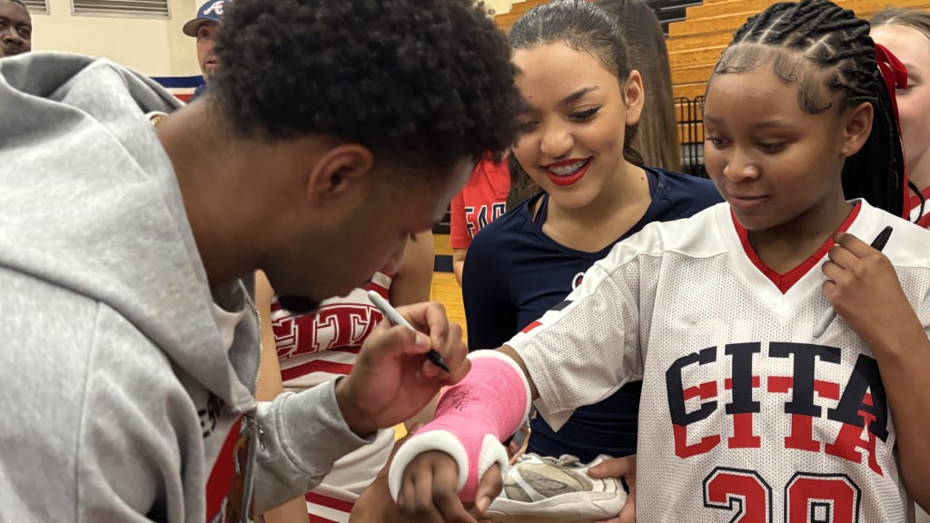 Brice Matthews signed the cast of a girl during his jersey retirement ceremony.