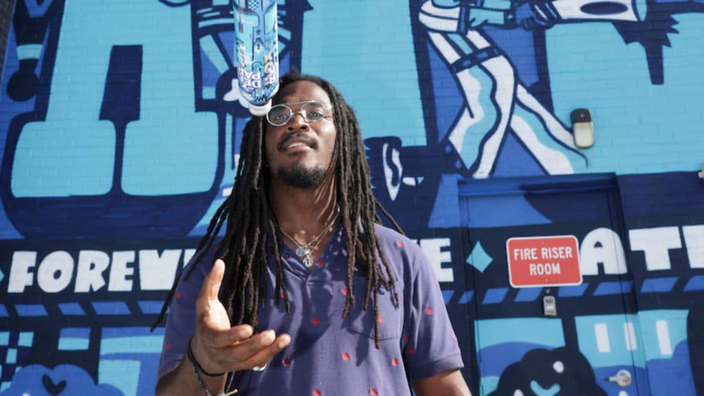 Artist George F. Baker III poses for a photo in front of the mural he created during the 2025 MLB All-Star 4.4 Miler mural unveiling at Center Parc Stadium on Sunday, July 13, in Atlanta.