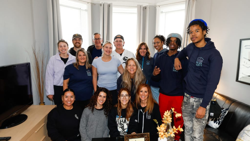 Andrew Vaughn (middle) and his wife, Lexi, alongside members of Digs with Dignity