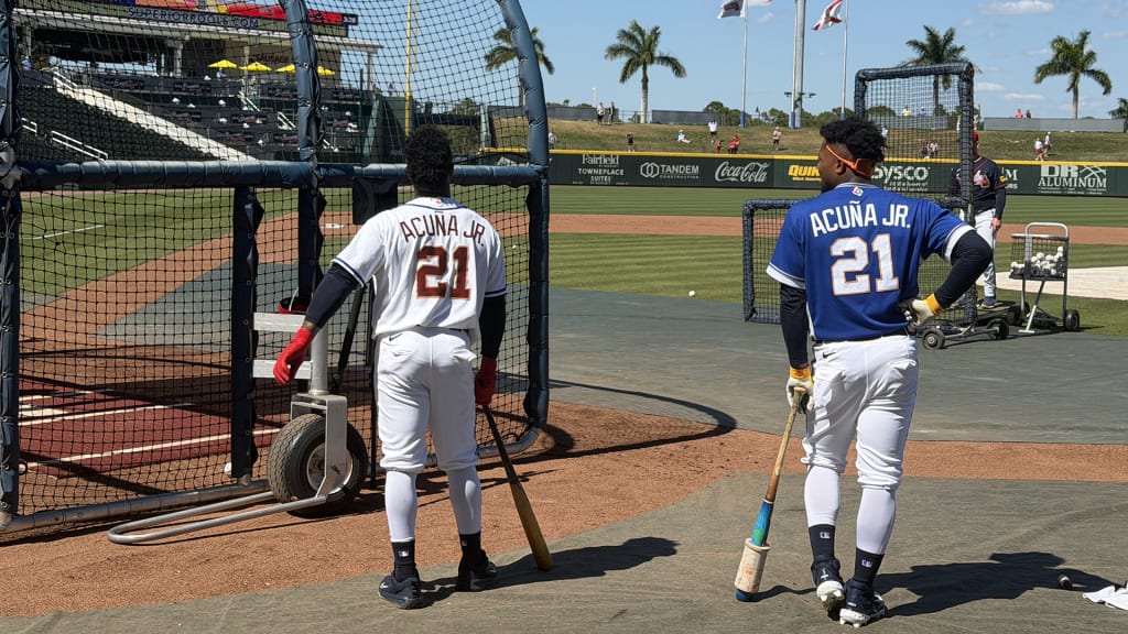 Ozzie Albies (left) wearing Ronald Acuña Jr.'s uniform