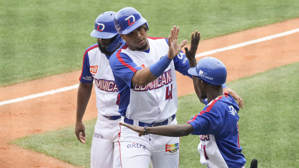 Ramon Hernandez (center) celebrates after scoring a run against Puerto Rico. (Ariana Cubillos/AP)