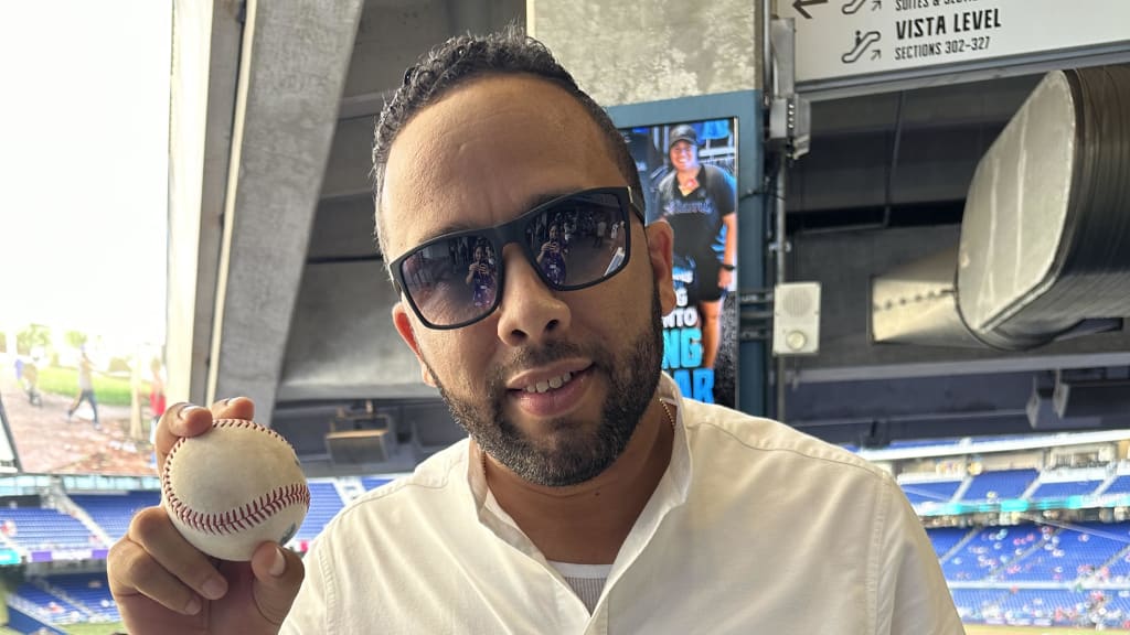 Marlins international area scout Angel Izquierdo holding Eury Pérez's pregame bullpen ball on Friday.