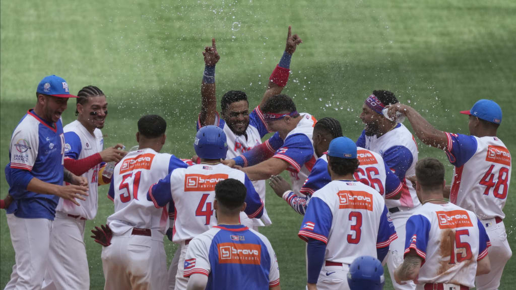 Puerto Rico players celebrate their crucial win over the Dominican Republic. (Fernando Llano/AP)