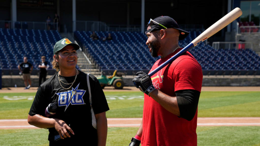 Alo speaks with a player out on the field.