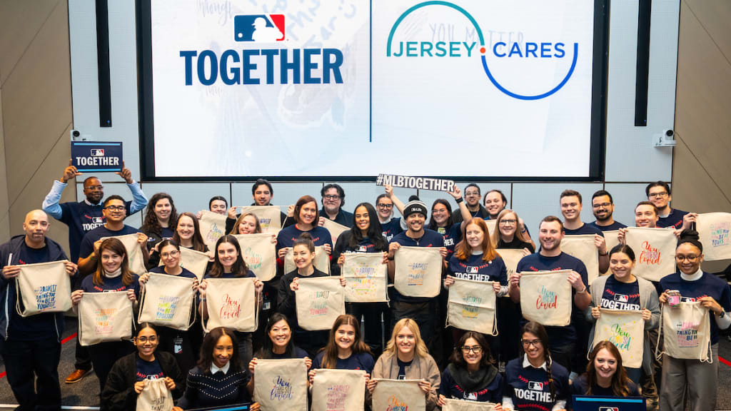Volunteers pose with completed kits during the volunteer event in partnership with Jersey Cares at MLB Headquarters. (Photo by Eve Kilsheimer/MLB Photos via Getty Images)