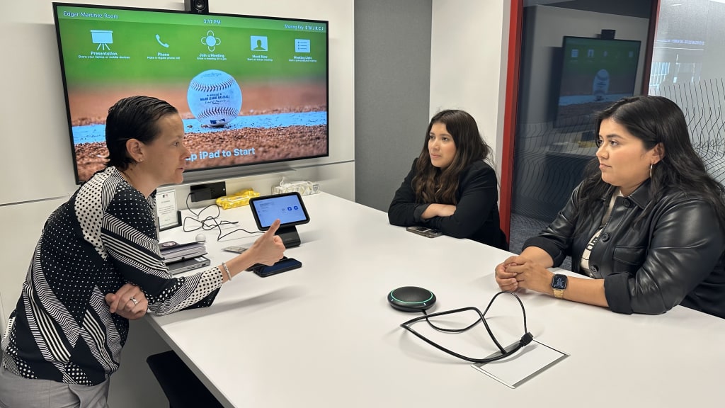 From left to right: Catalina Villegas, MLB's Director of Diversity, Equity and Inclusion, speaks with Martinez-Lopez and Ramírez.