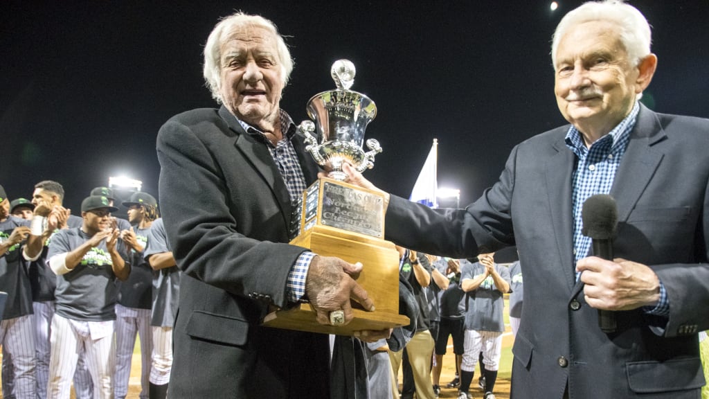 Emeralds owner Dave Elmore (left) receives the Freitas Cup from league president Mike Ellis (right) after Game 3 of the Northwest League Championship Series on Sept. 13, 2016.