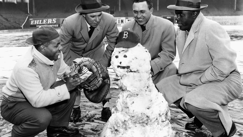 (From left) Roy Campanella, Pee Wee Reese, Gil Hodges and Jackie Robinson gather around a snowman on the diamond at Ebbets Field on April 14, 1950.