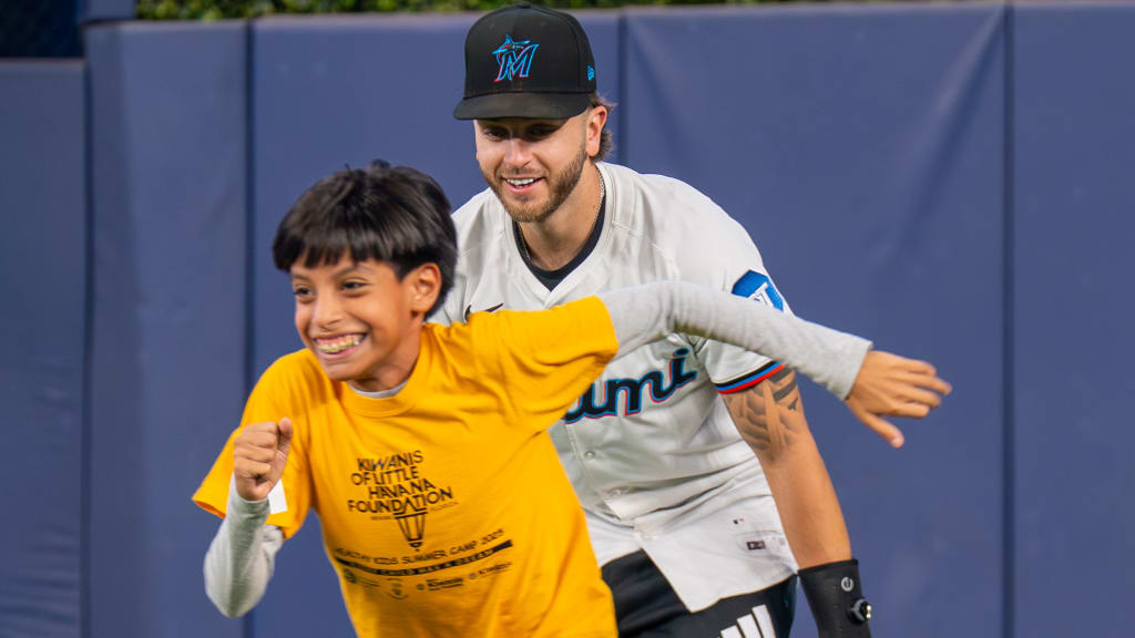 Connor Norby interacts with a participant at the Marlins' P.L.A.Y. (Promoting a Lifetime of Activity for Youth) clinic.