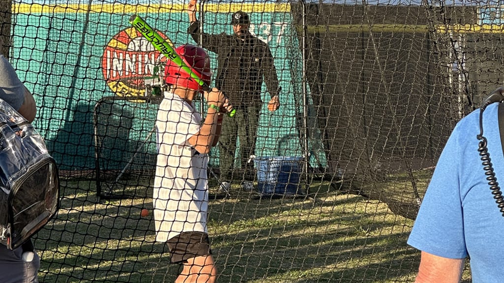 Matt Kemp feeds the machine to a batter in a Mookie Betts Dodgers jersey