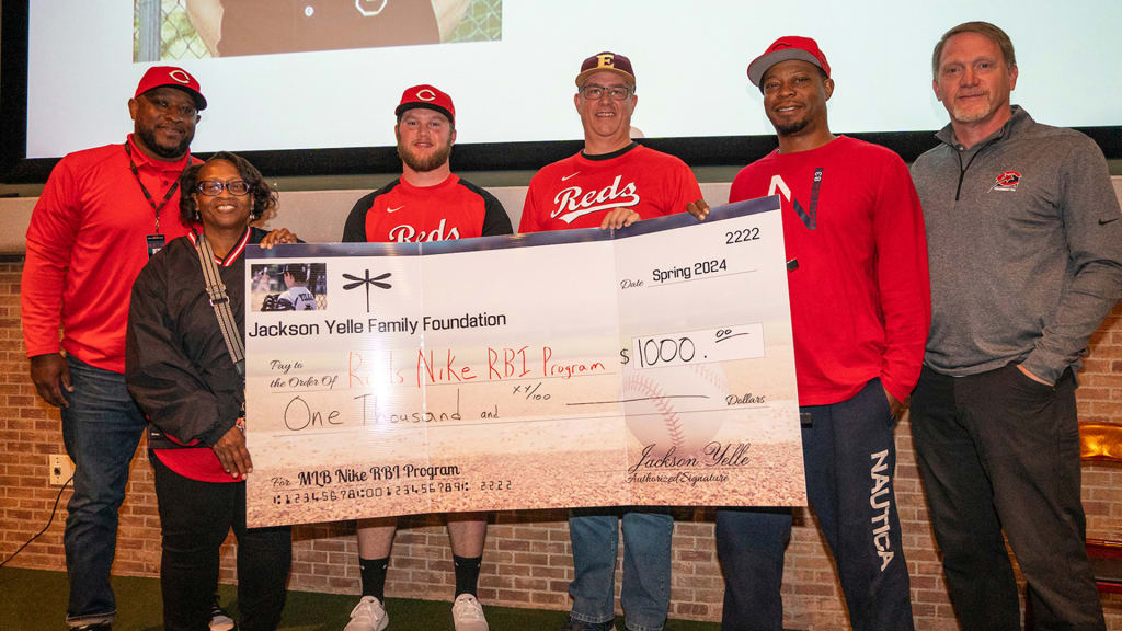 Scott Yelle (fourth from left) presents a $1,000 check to the MLB Nike RBI Program.
