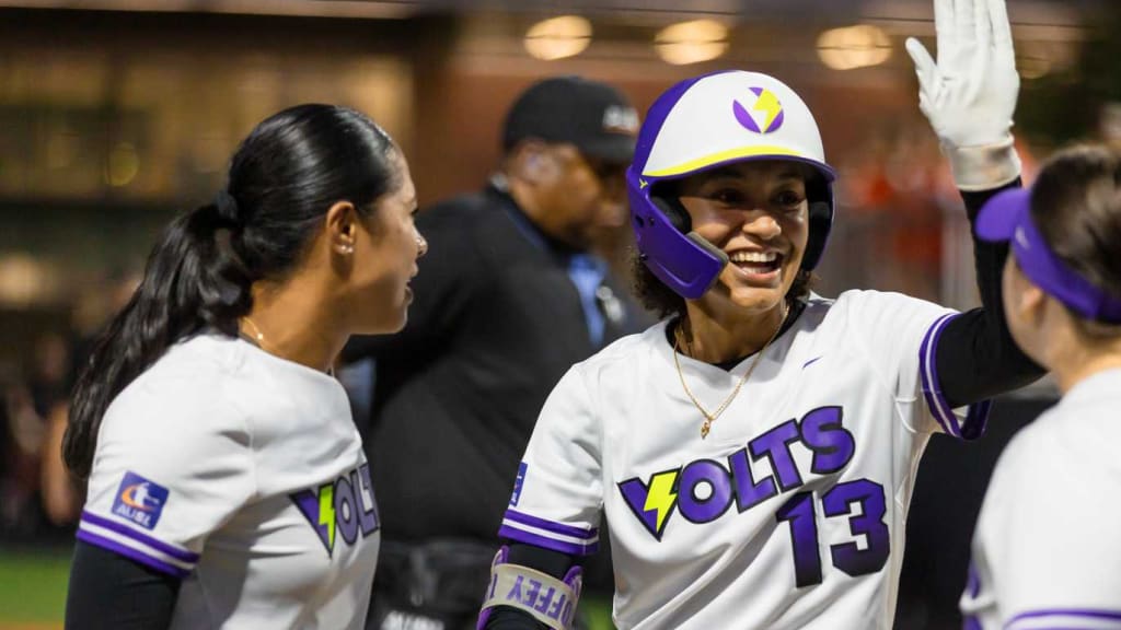 Dejah Mulipola (left) and Danieca Coffey celebrate after Coffey's second-inning home run for the Volts.