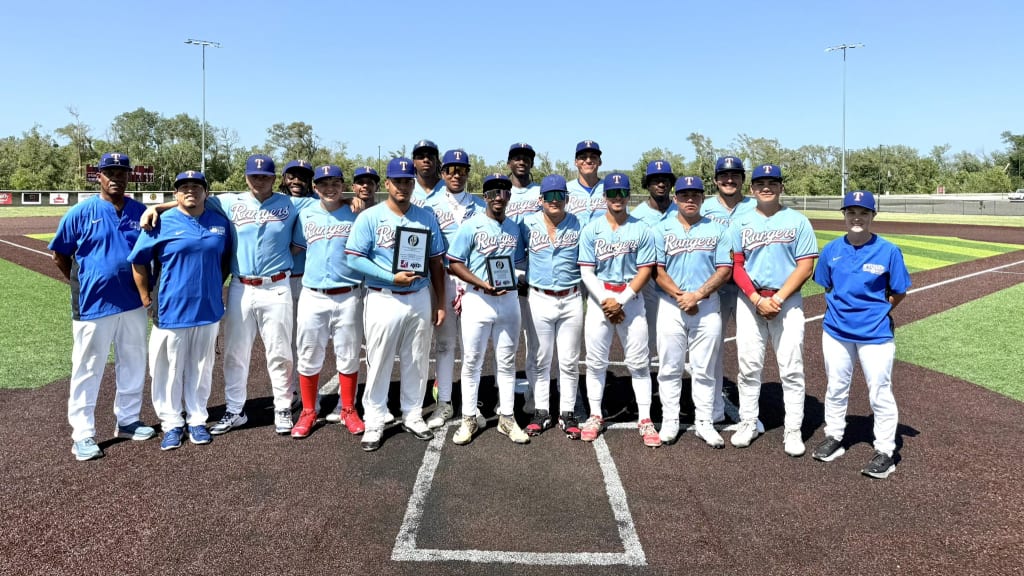 The Texas Rangers Youth Academy 18U Scout Team poses at home plate after winning the inaugural Bob Gibson Juneteenth Tournament in Omaha, Neb.