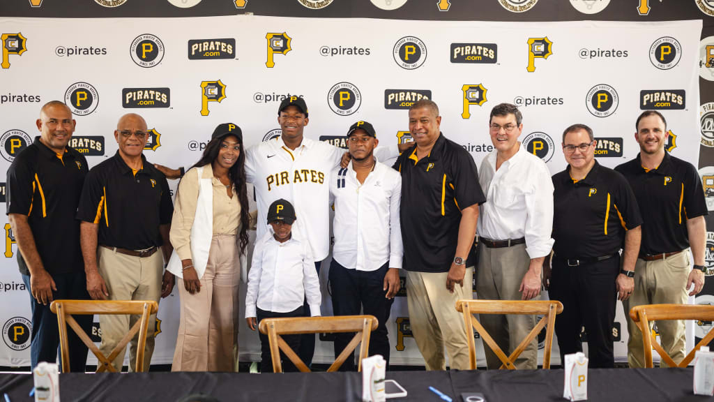 Bralyn Brazoban (in Pirates jersey) is joined by his family and team officials.