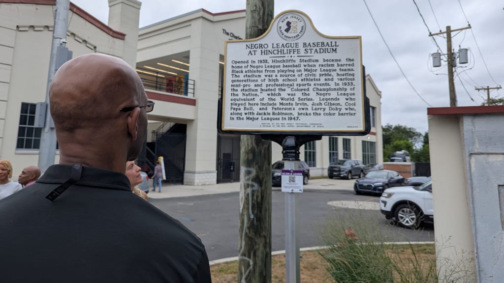 Larry Doby Jr. reads the marker after pulling the cover off of it.