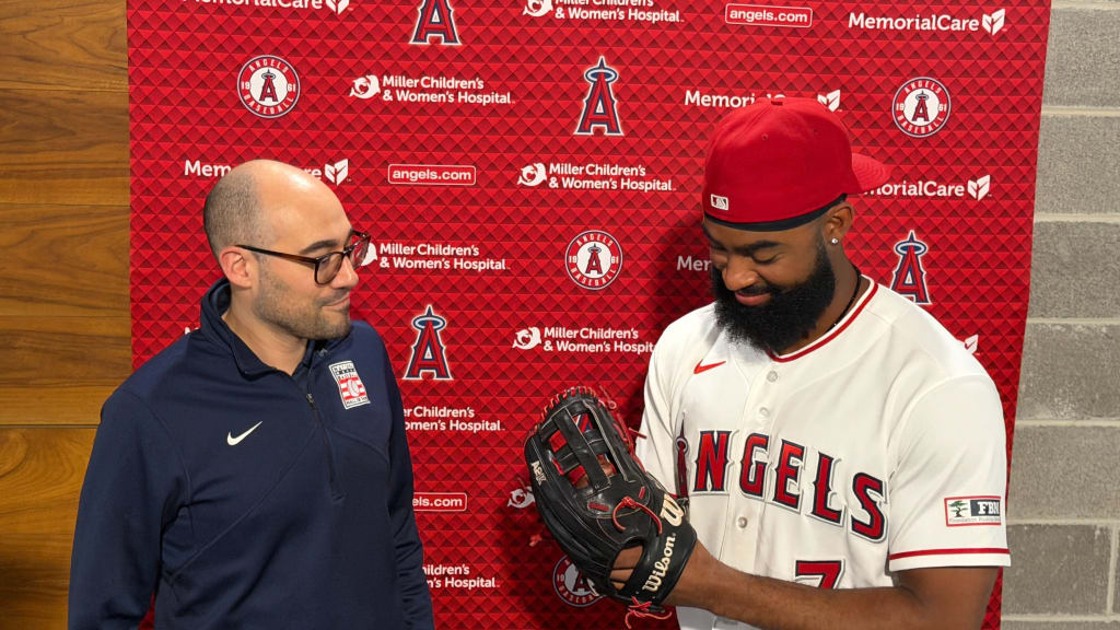 Jo Adell, pictured here with Hall of Fame vice president Jon Shestakofsky, said he initially planned to use the glove all season, but he then changed course and donated it to the Hall before the Angels' series finale against the Yankees.
