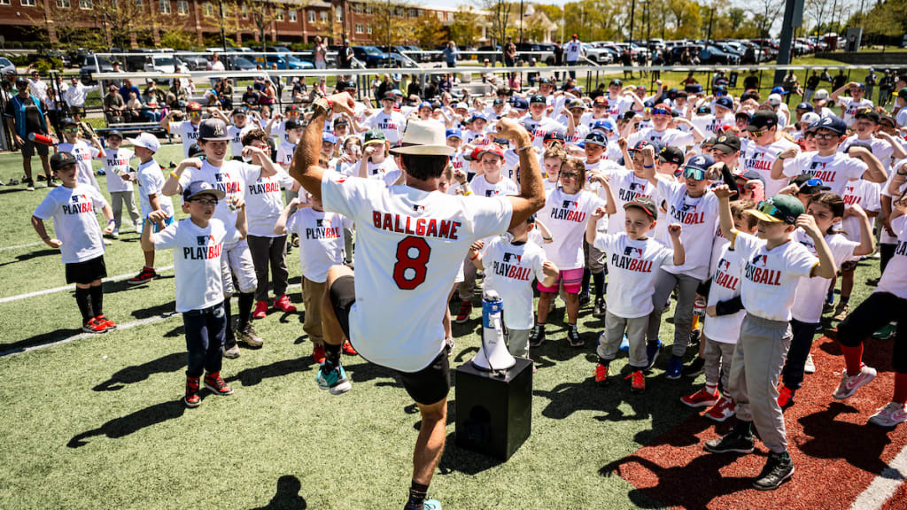 Attendees participate in an activity led by James Lowe during MLB Play Ball event in Plymouth, Massachusetts.
