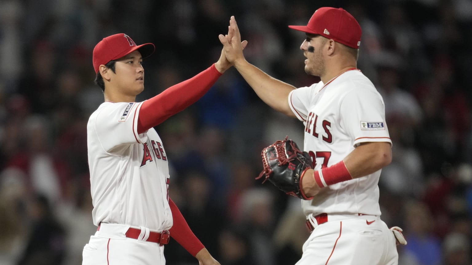 Shohei Ohtani high-fives Mike Trout