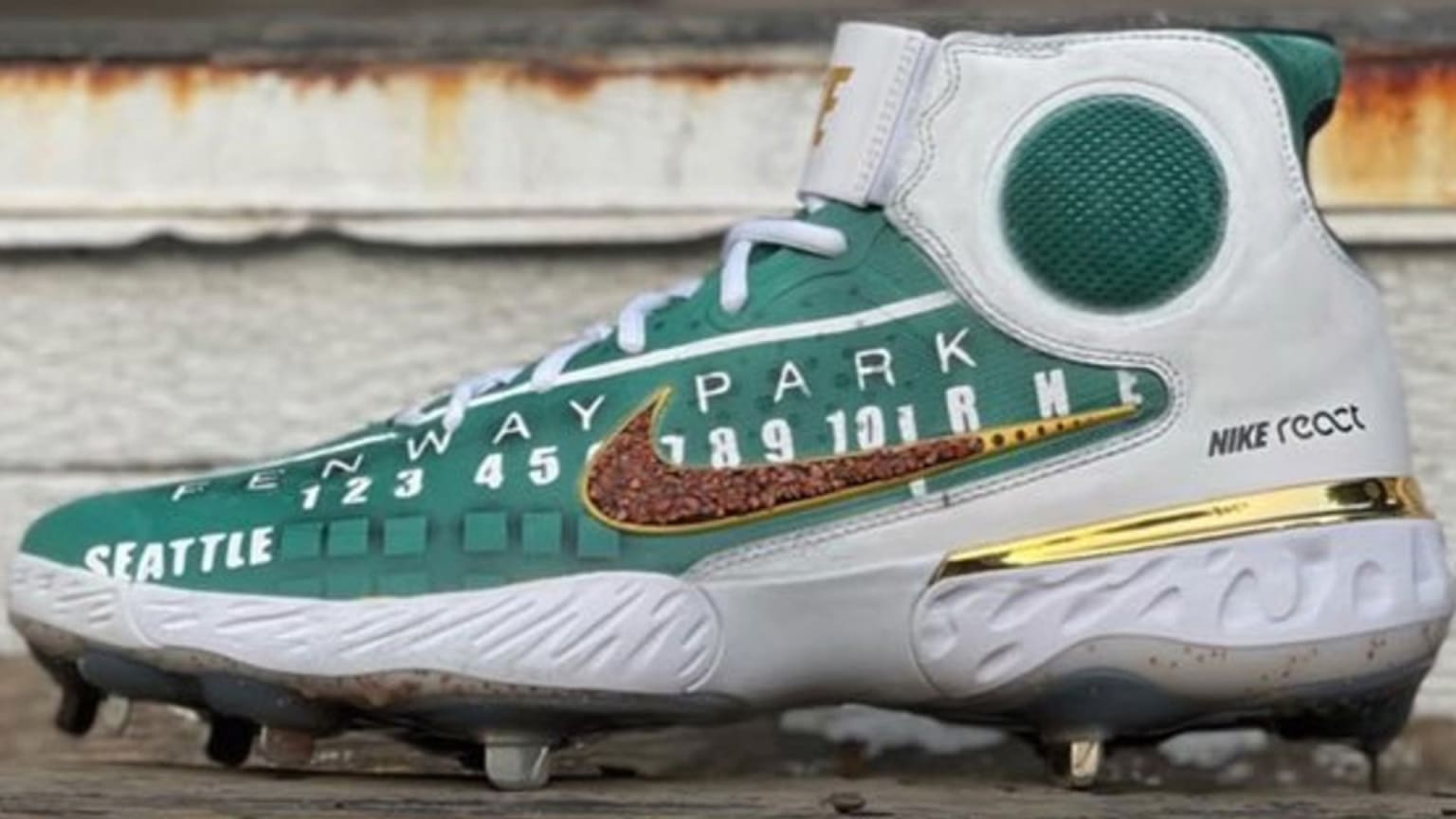 An image of the Fenway Park scoreboard and dirt from the stadium are featured on a cleat