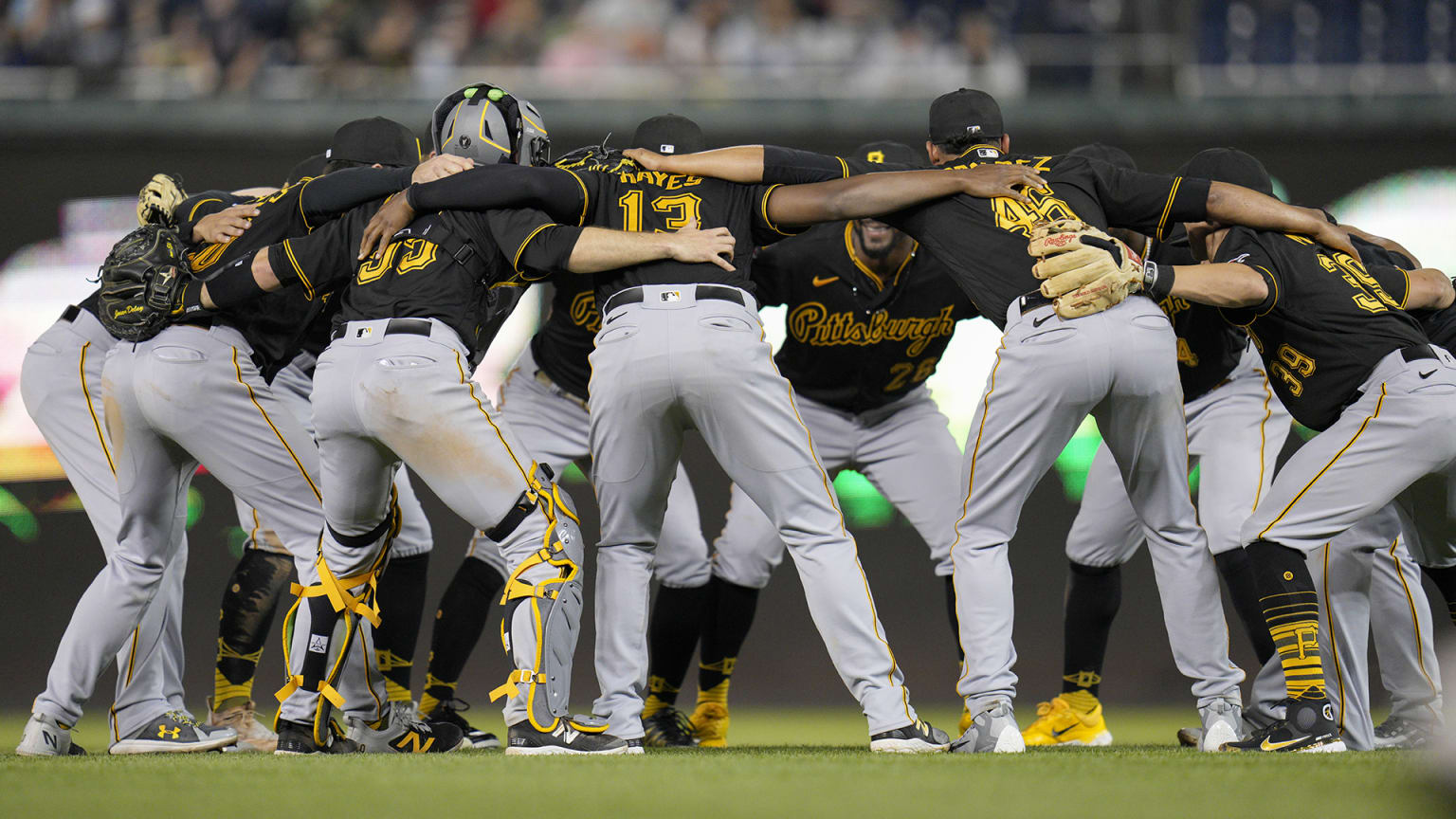 The Pirates huddle in a circle celebrating a recent win