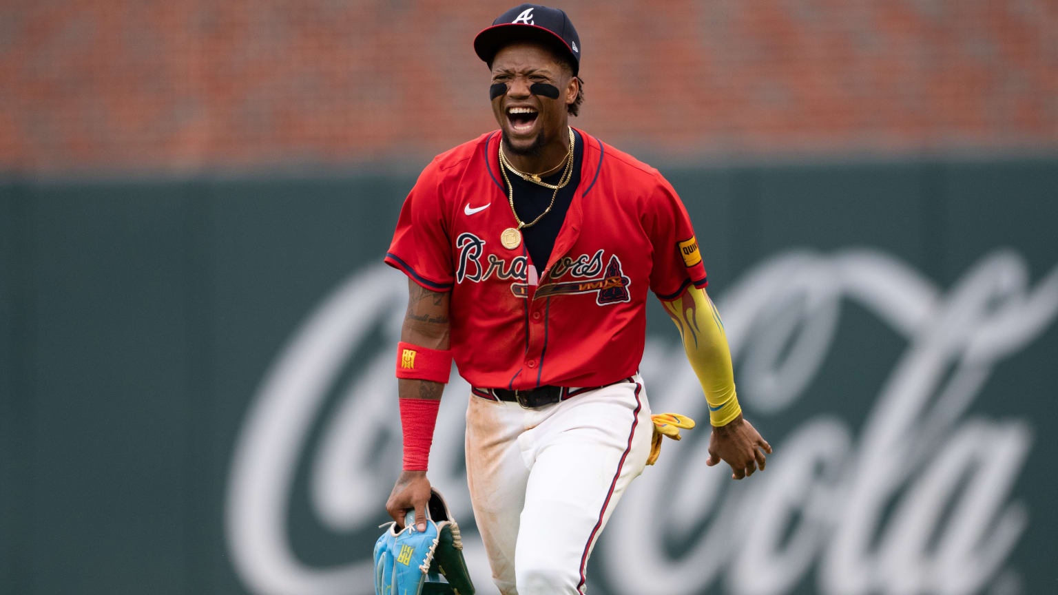 Ronald Acuña Jr. celebrates after throwing out a runner at third base