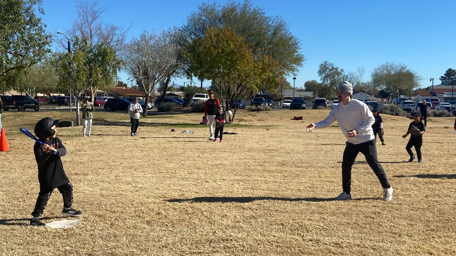 Corbin Carroll tosses a pitch to a child