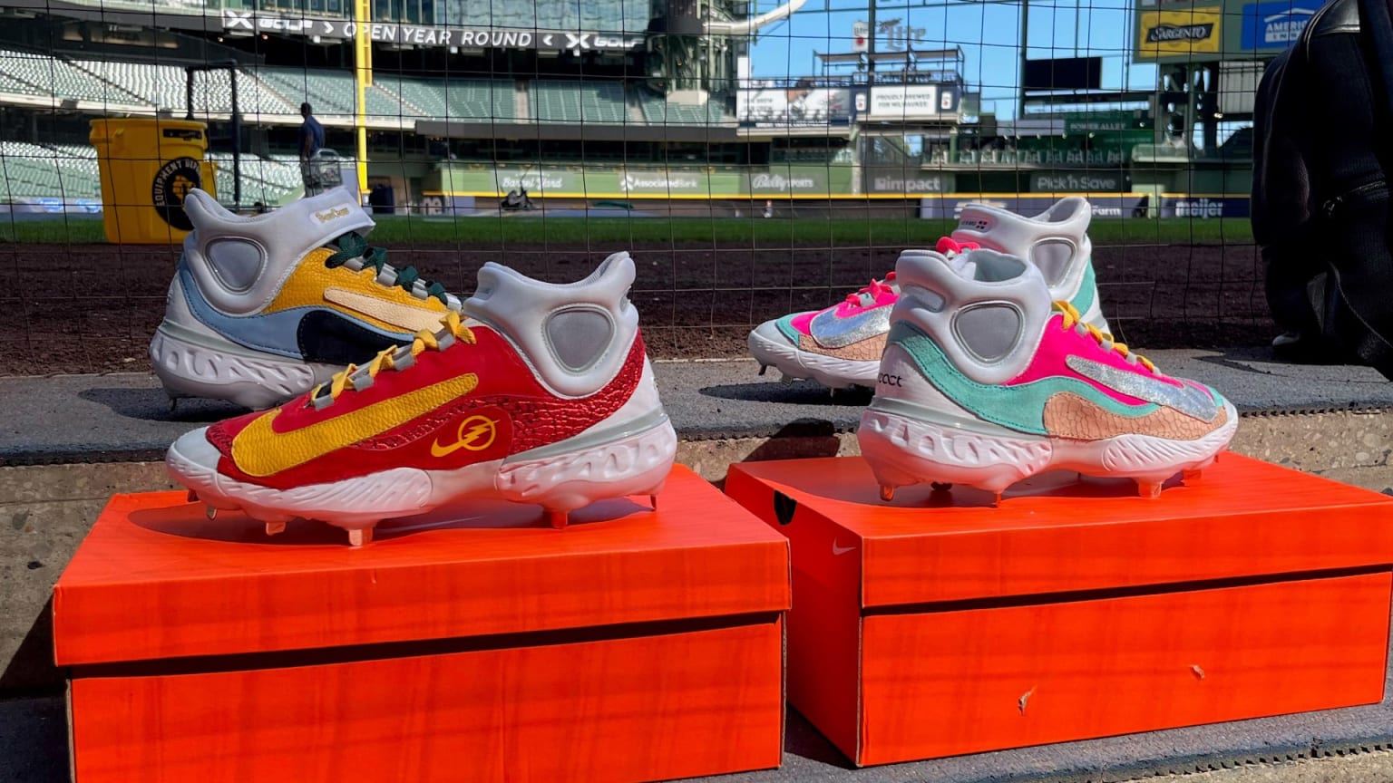 Four colorful cleats are displayed