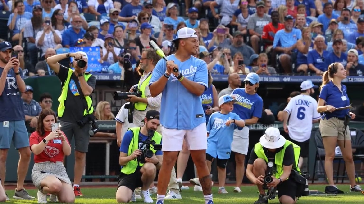 Patrick Mahomes bats during a softball game