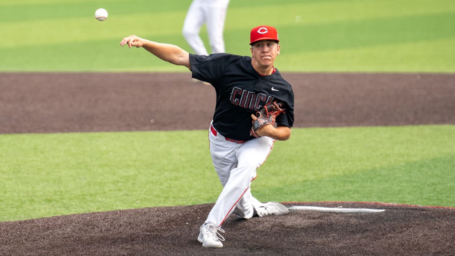 A young pitcher releases a pitch