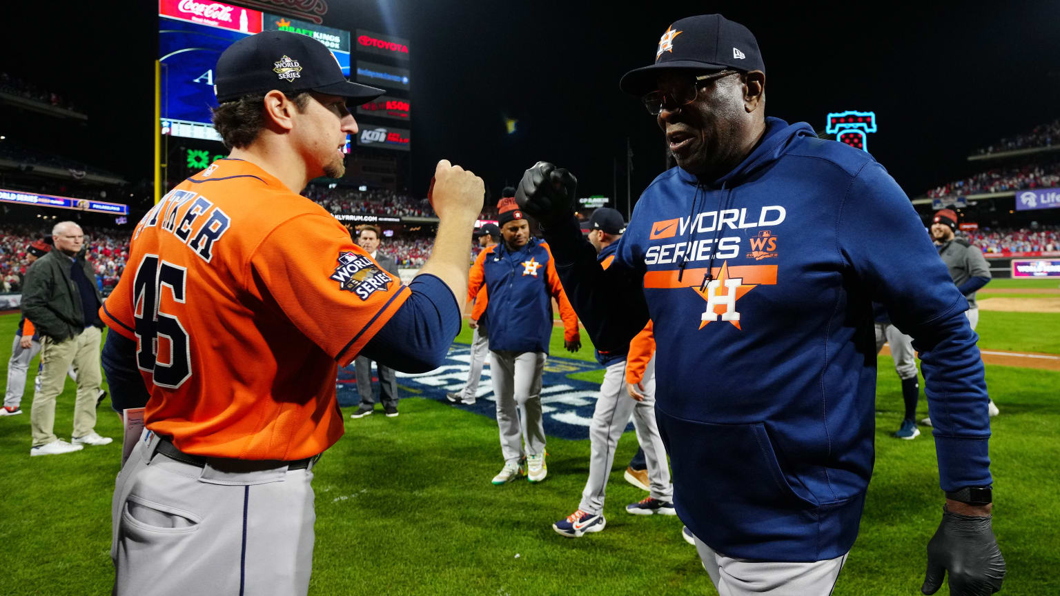 Astros coach Troy Snitker and manager Dusty Baker bump fists