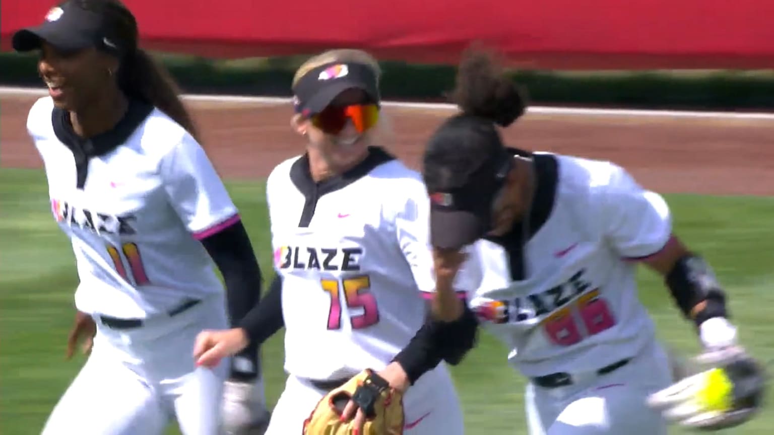 Blaze players celebrate McKenzie Clark's diving catch